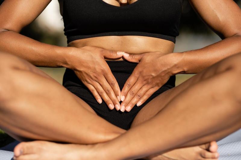 Seated person holding stomach
