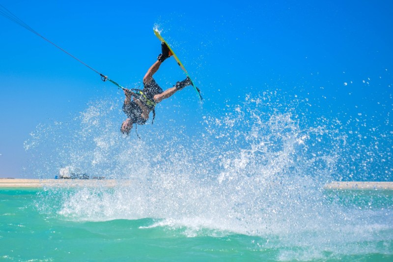 A kitesurfer flipping in the warm water at Fuwairit Kite Beach