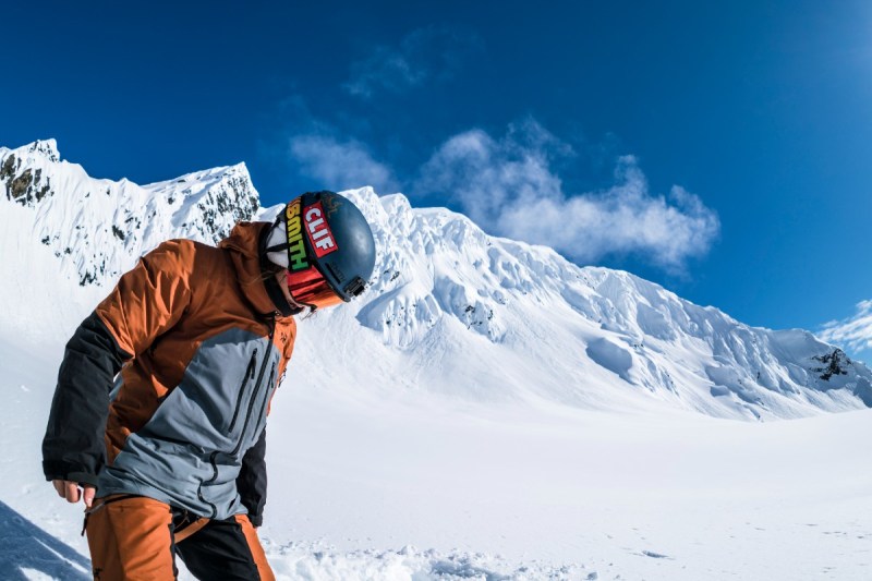 Elena Hight on a snowboard in mountainous backcountry.