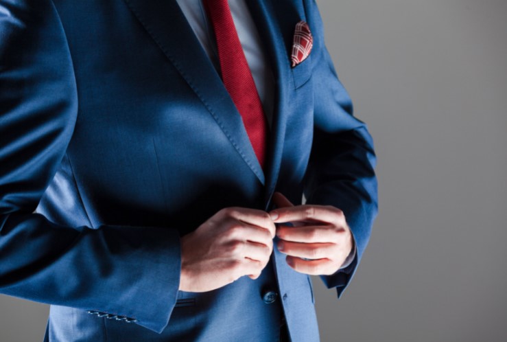 Man in white shirt, blue jacket and red tie Stock Photo