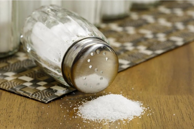 Salt shaker will salt pouring out.