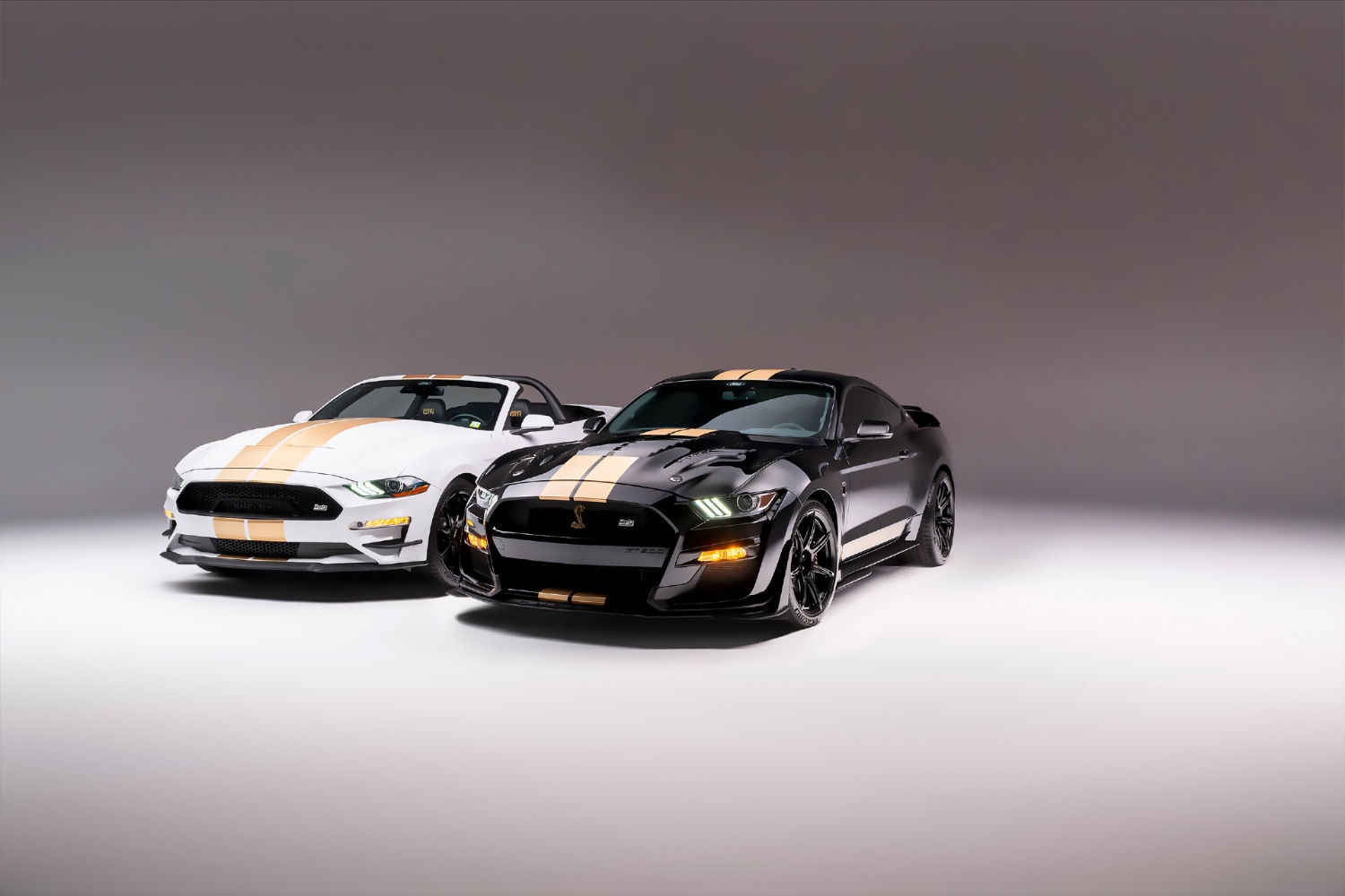 2022 Shelby GT-H Convertible and Shelby GT500-H next to one another in a studio with a gray background.