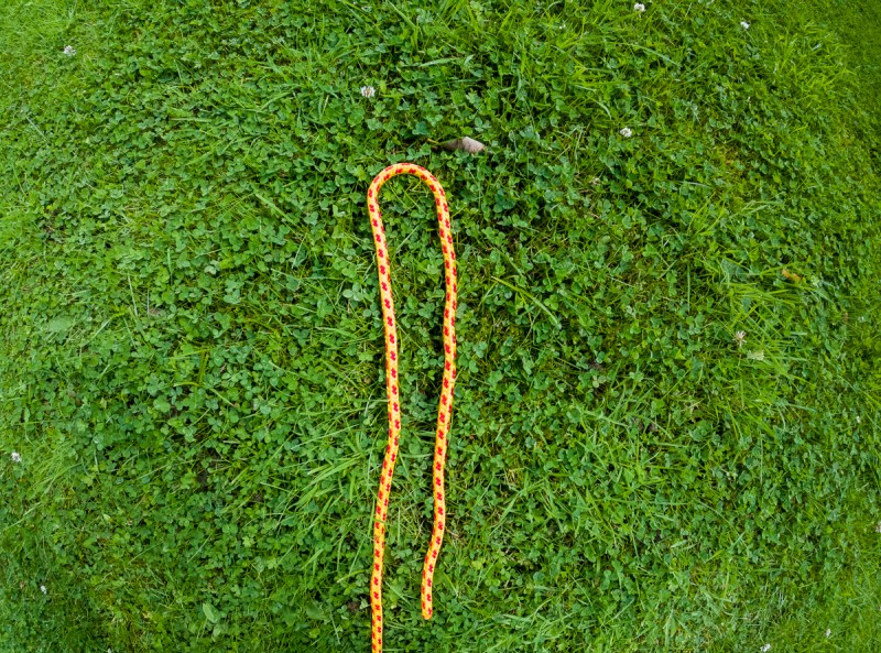 A bight of yellow and red rope on the grass