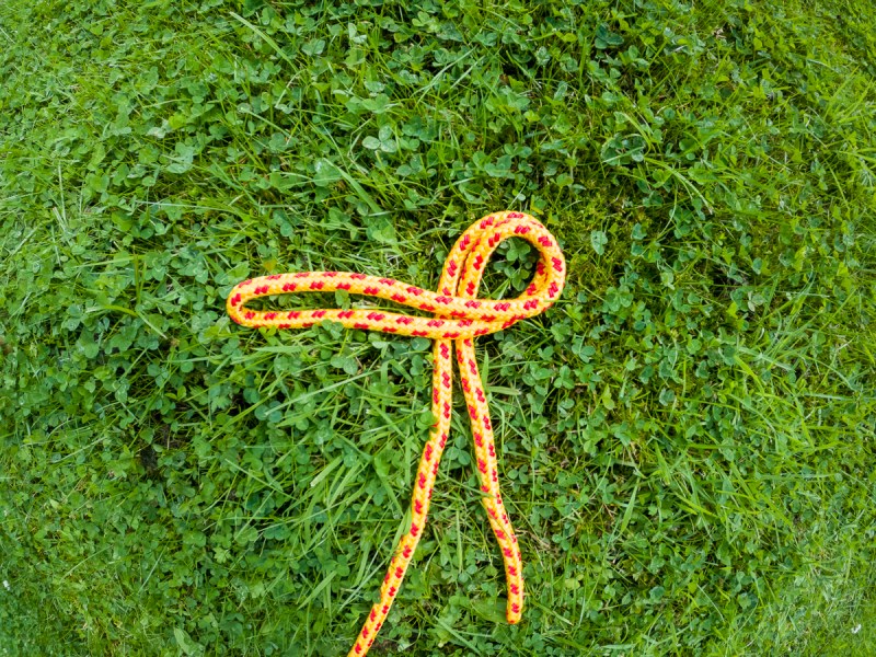 A bight of rope on the grass, laid out in a loop