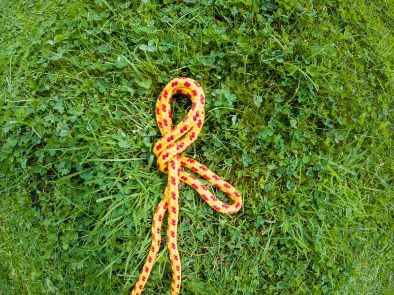 A bight of rope tied into a loop laid out on the grass.