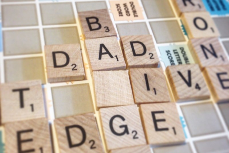 The letters on the Scrabble board read, dad, die, and more.