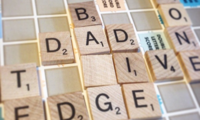 Letters on a Scrabble board spell out, Dad, Die and more.