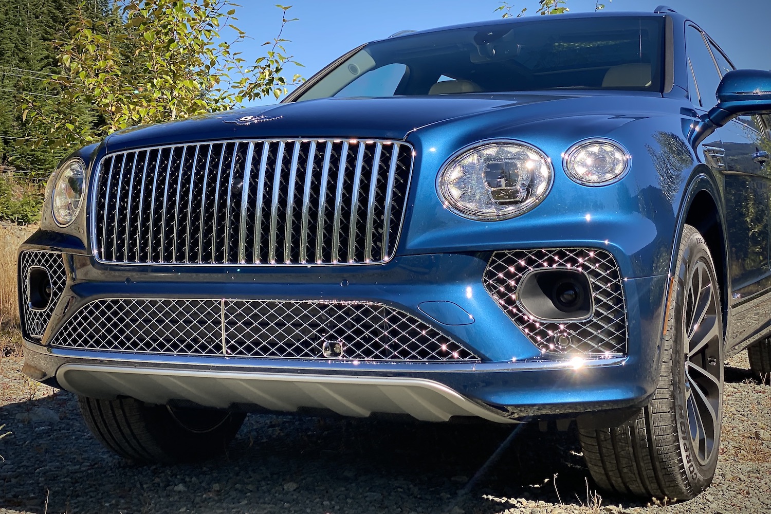 Front end close up of 2023 Bentley Bentayga EWB headlights and new vertical grille.