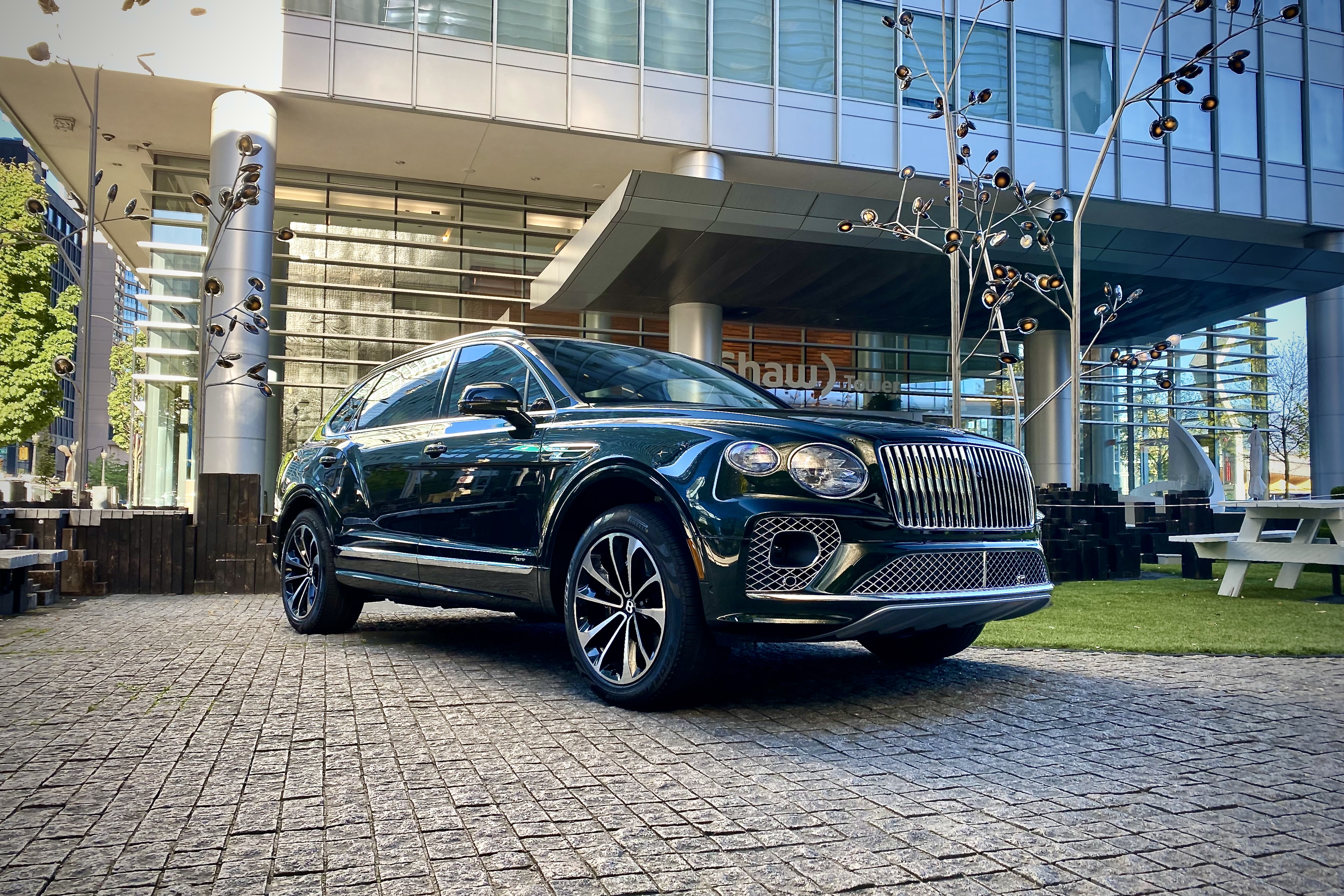 Front end of 2023 Bentley Bentayga EWB from passenger's side in front of a hotel.