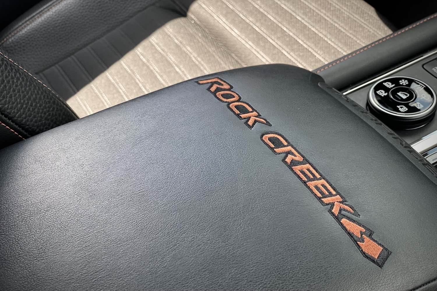 Close up of Rock Creek badge on the 2023 Nissan Pathfinder Rock Creek center console storage compartment.