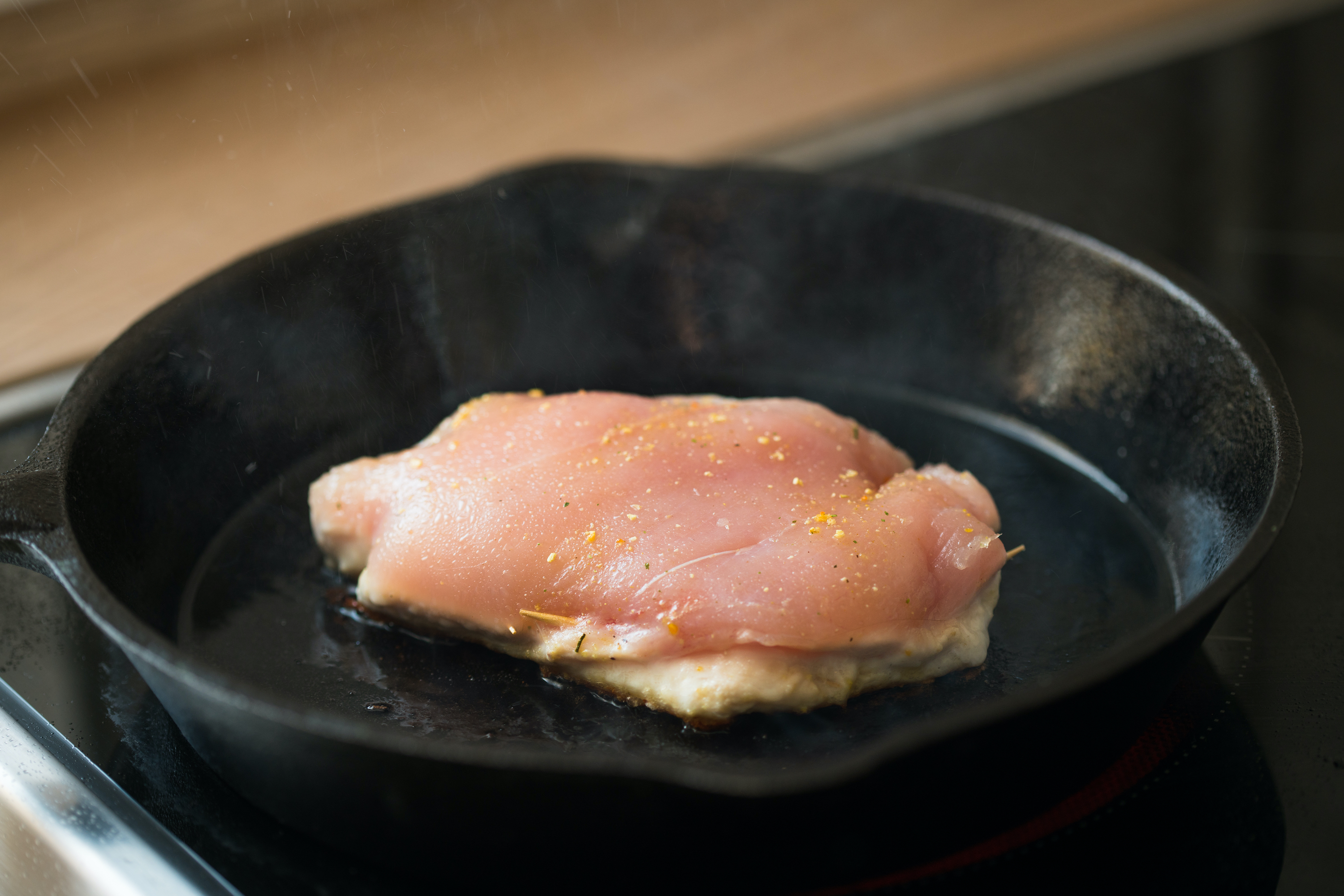 raw chicken breast in a pan