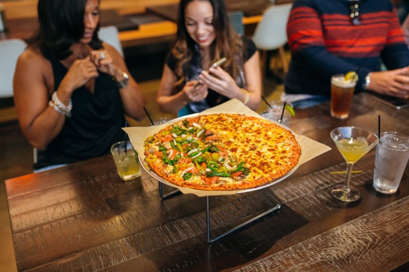 Customers enjoy Columbus-style pizza.