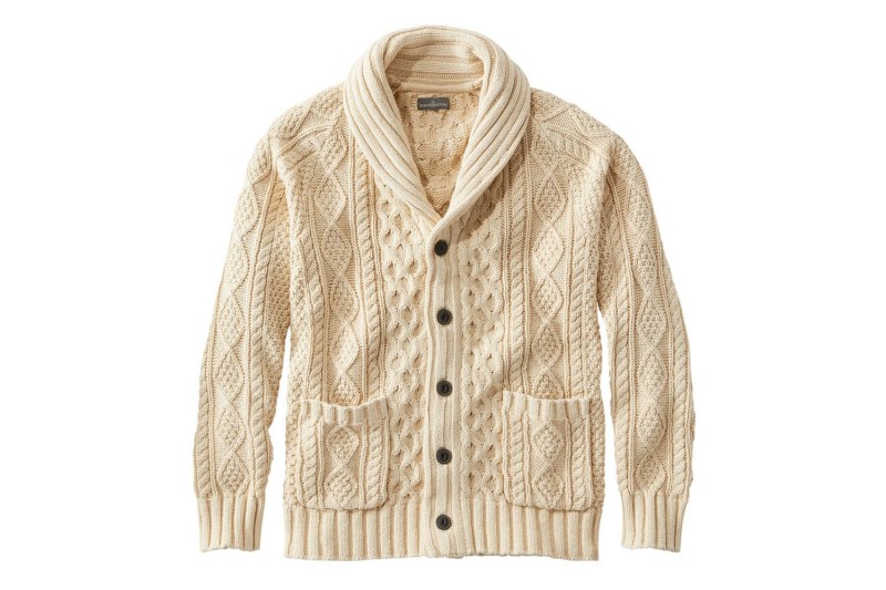 A cream colored cable knit shawl collar cardigan.
