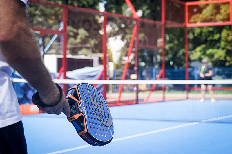 Player holding a padel paddle.