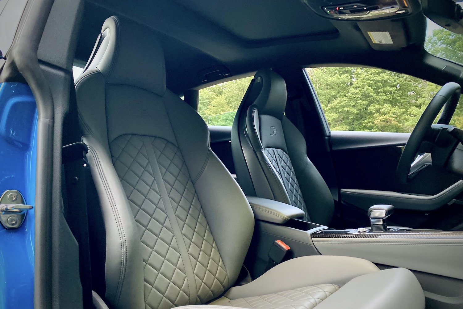 2023 Audi S5 Sportback close up of front passenger seat with trees in the back.