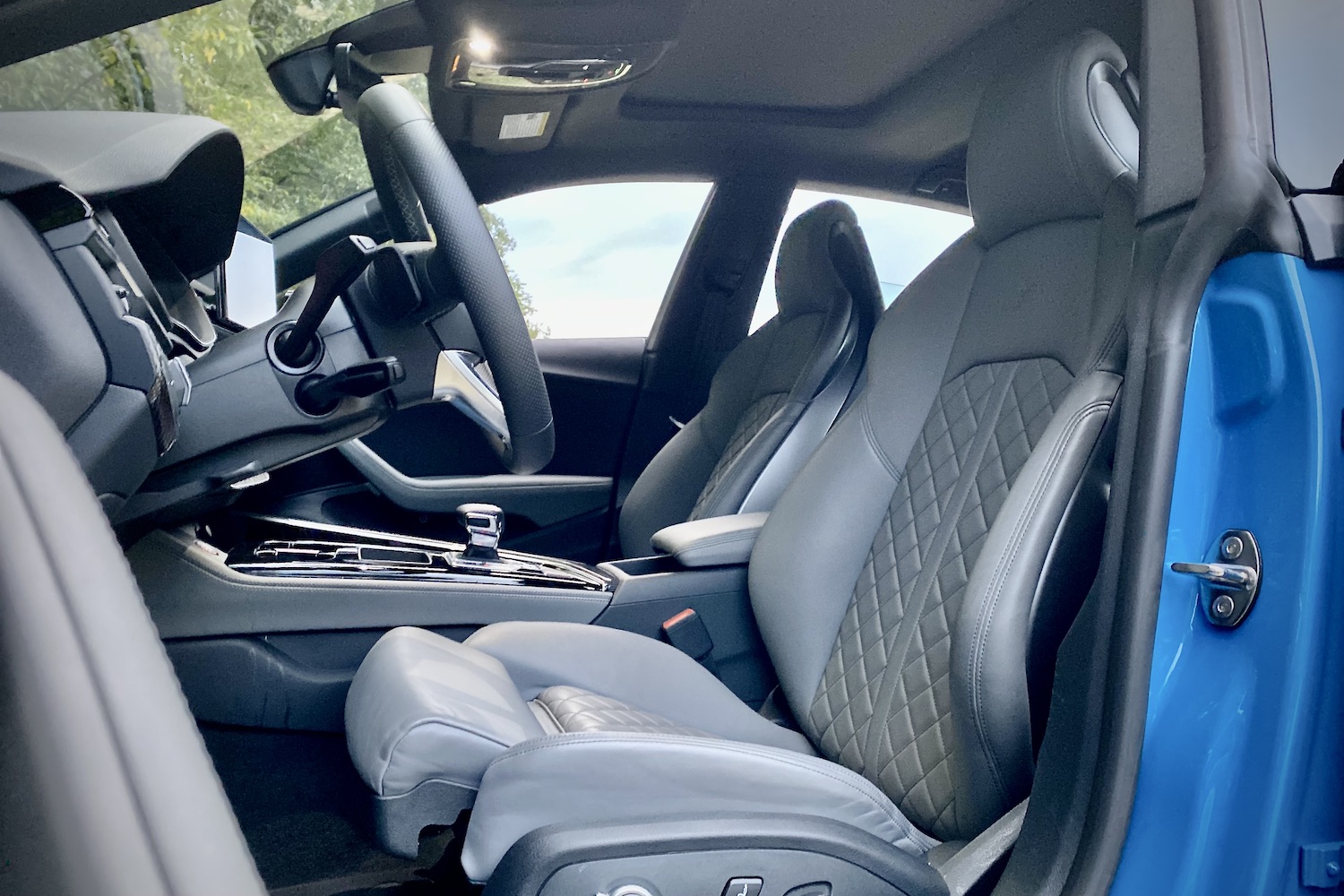 2023 Audi S5 Sportback close up of front seats from outside the vehicle during a sunset.