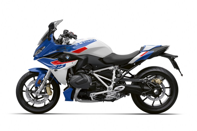 2023 BMW R 1250 RS with a white, red, and blue paint job from the side profile with a white background.