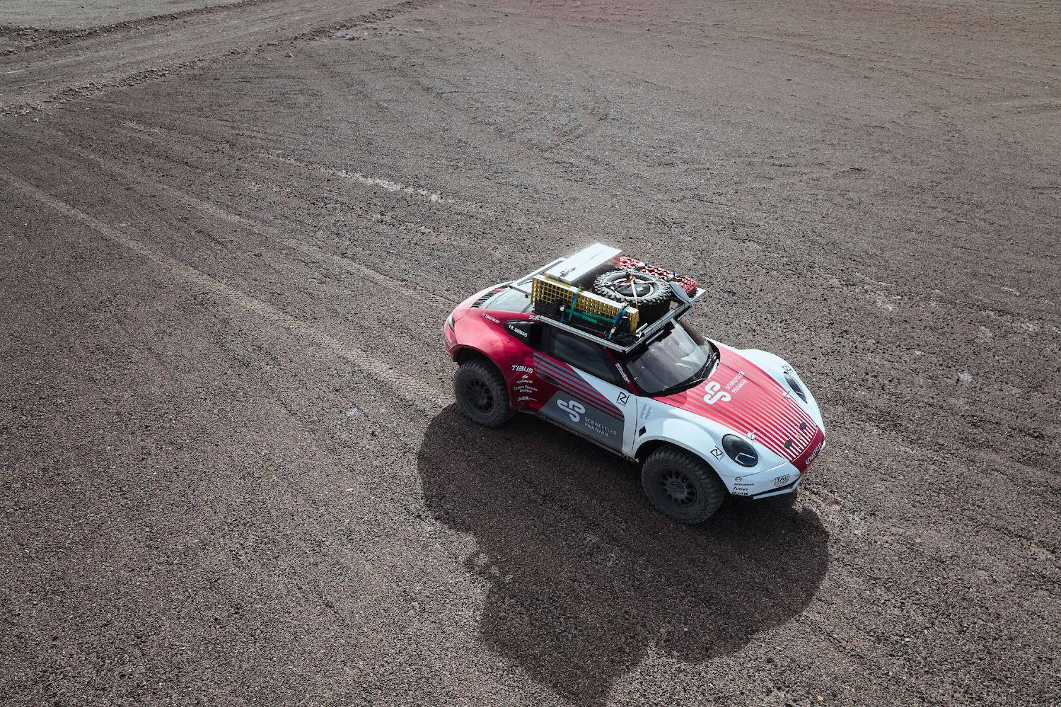 Overhead angle of Porsche 911 Dakar Prototype on rocky terrain.l