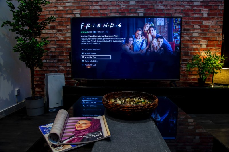 living room with Friends on TV screen