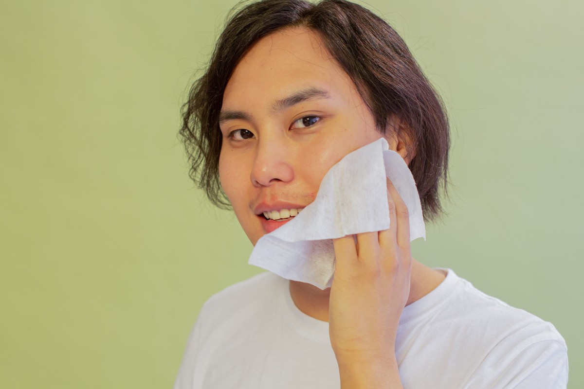 a man wiping his face