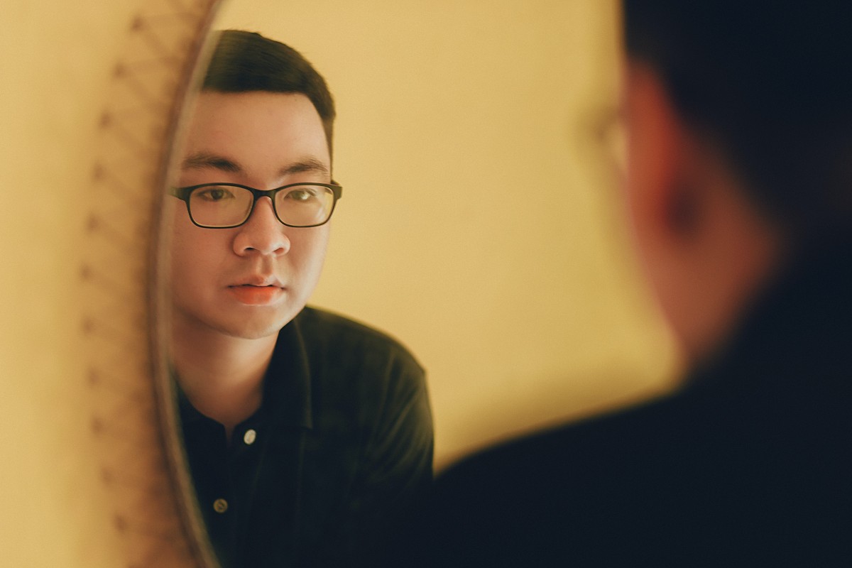 a man looking at himself in the mirror