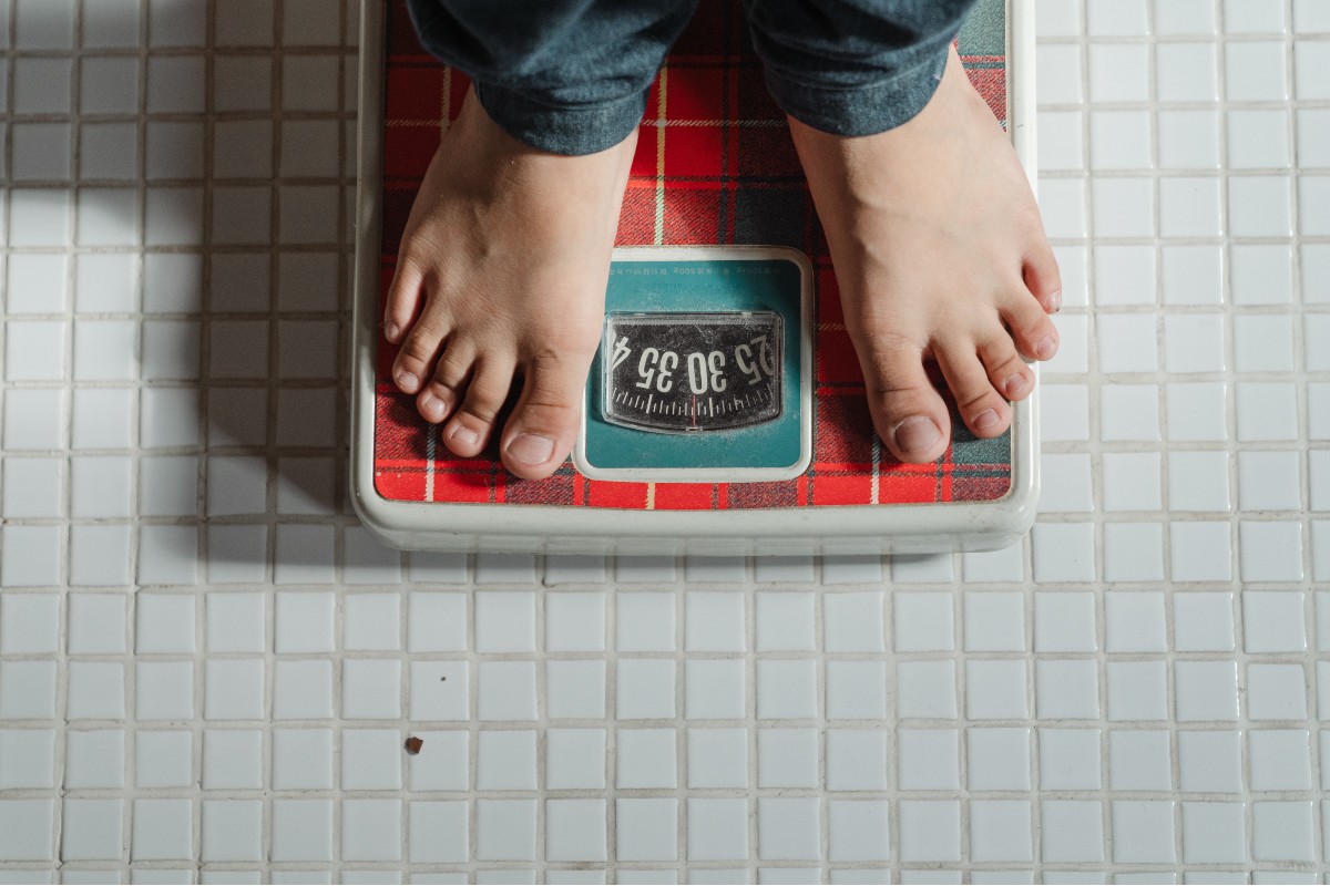 a person weighing themselves