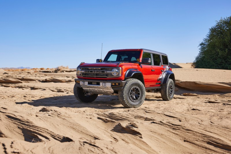 2022 Ford Bronco Raptor front end angle from driver's side in sand dunes.