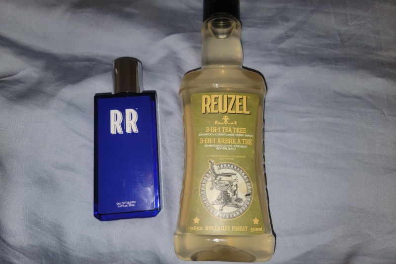 A bottle of Reuzel 3-in-1 Tea Tree Shampoo.