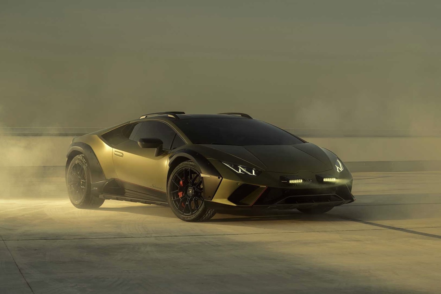 2023 Lamborghini Huracan front end angle with smoke in the back in front of a city skyline on top of a roof.