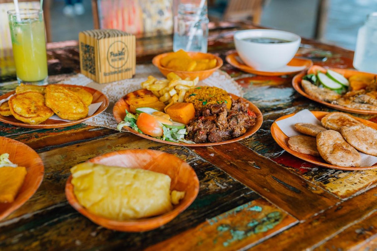 A table with many plates of food at Posada Para Mira Bonaire.