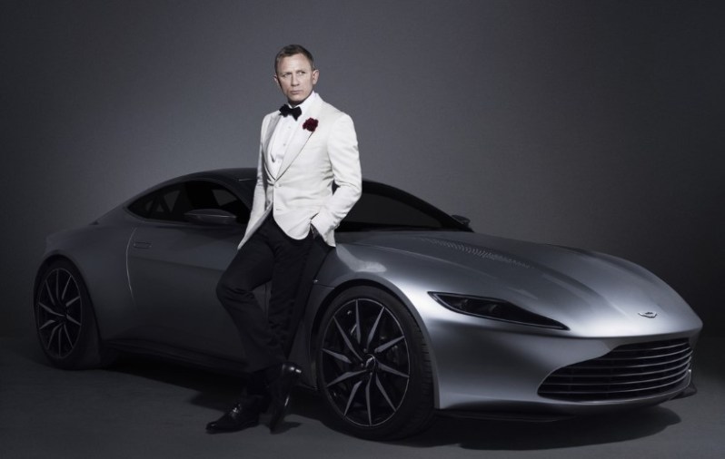 James Bond leaning on Aston Martin