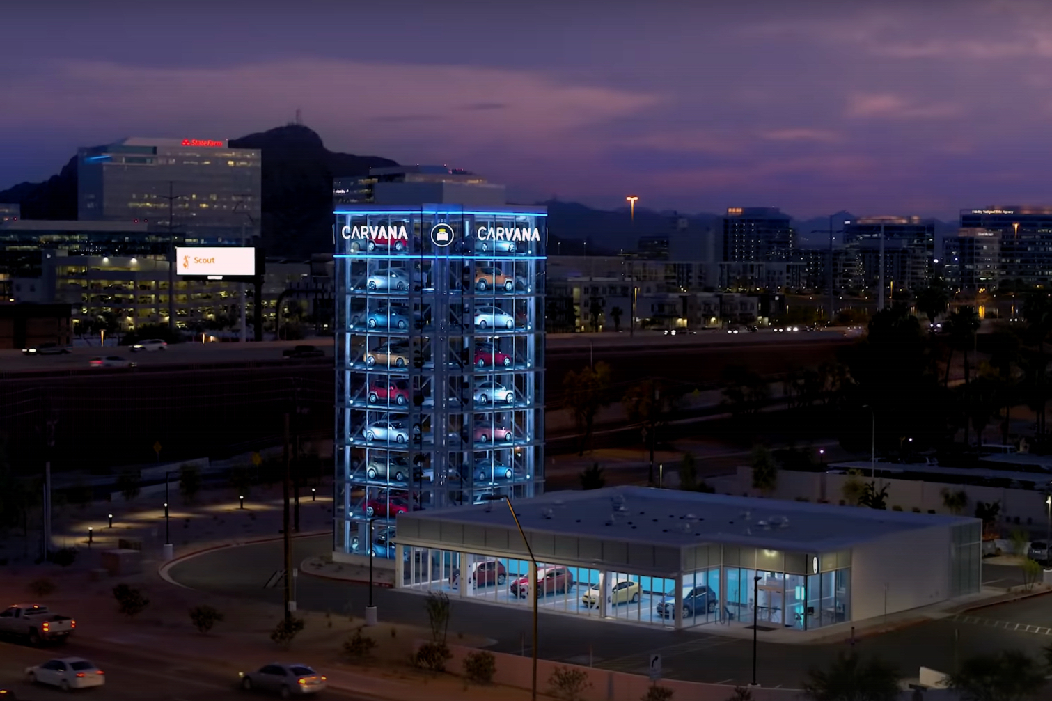 Carvana Vending Machine during sunset in front of large buildings.