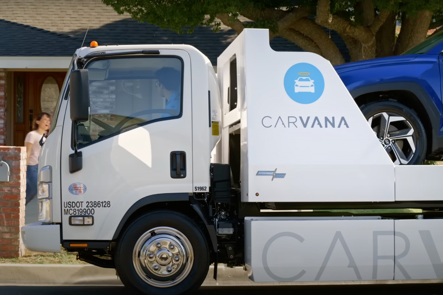 Close up of Carvana transporter with car on the back.