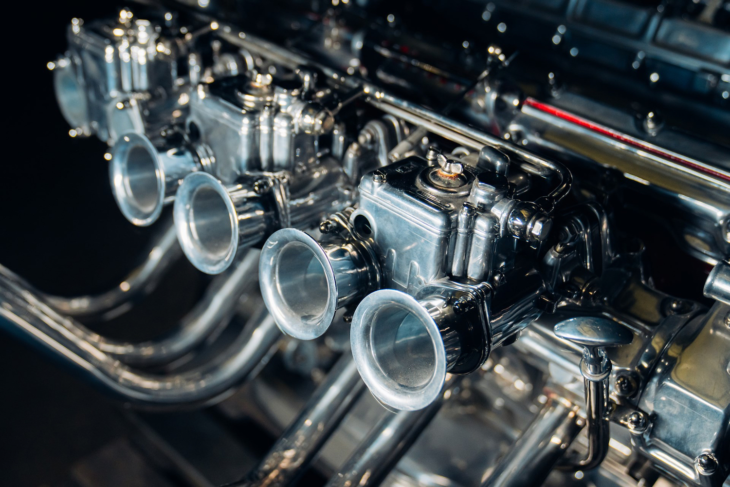 Top view of intakes on Ferrari V12 Table in front of a black screen.