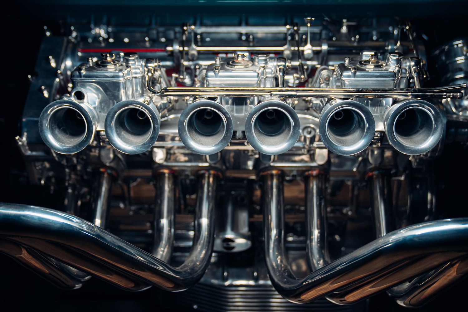 Close up of intake on Ferrari V12 Table in front of a black screen.