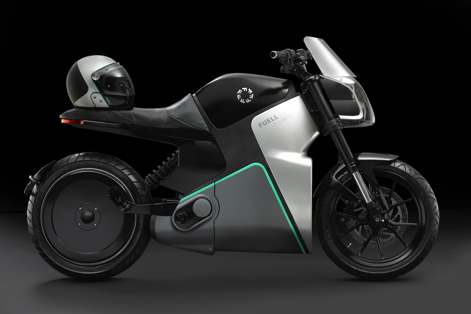 Side profile of Fuell Fllow all-electric motorcycle in front of a black screen.