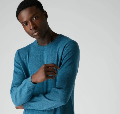 A man in a teal long-sleeved shirt