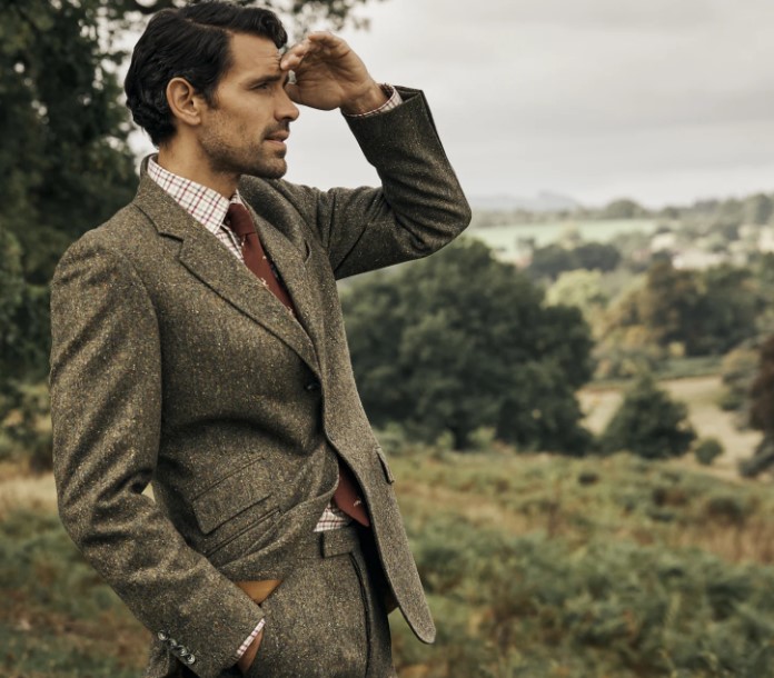 Man in a tweed suit, standing in a field