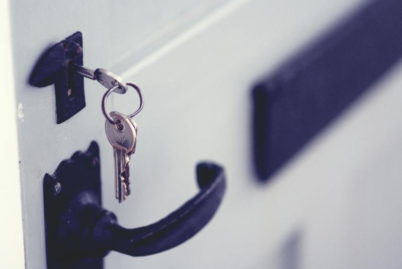 Closeup of a set of keys in a door lock.