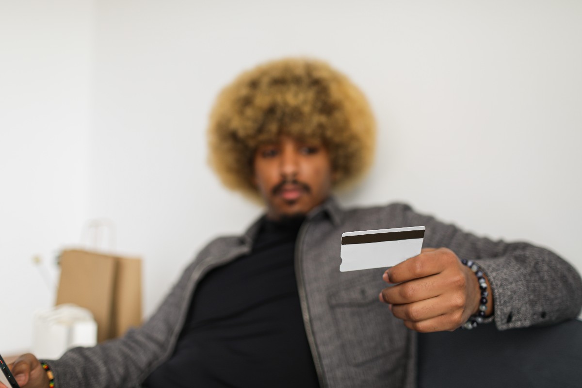 a man looking at a credit card