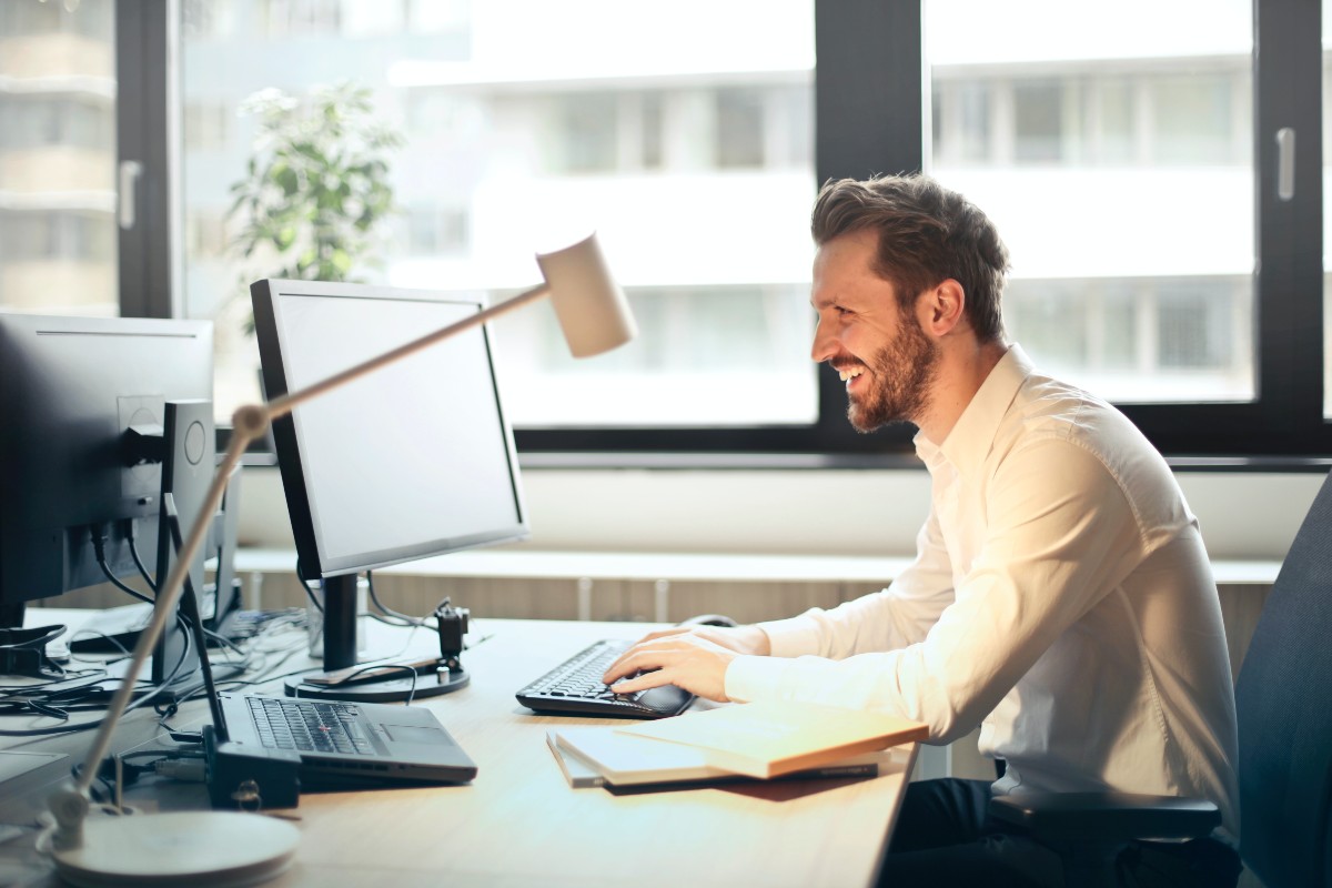 a person on computer at work smiling