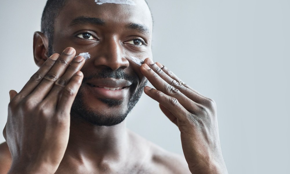 Man applying cream to his face