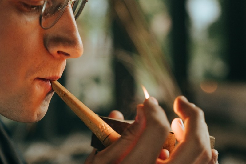Closeup of a man smoking a pipe.