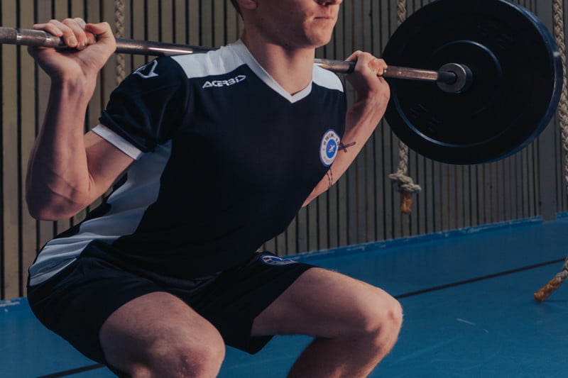 Man performing a squats with heavy weight