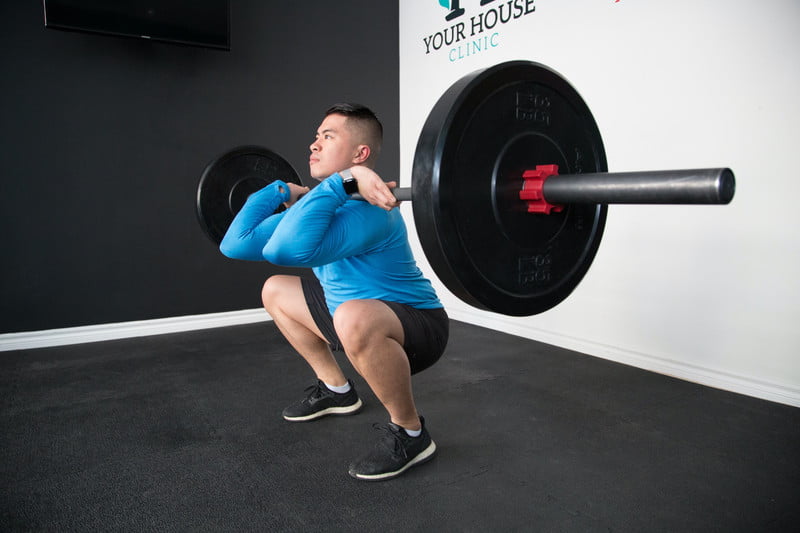 Man doing squats with heavy weight