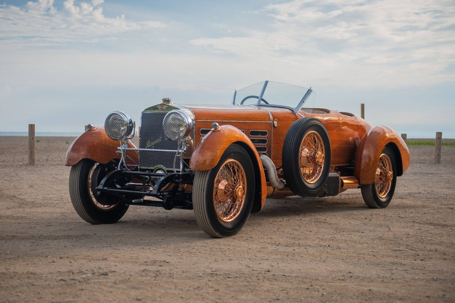 1924 Hispano-Suiza H6C “Tulipwood” Torpedo front end angle from driver's side parked in a dirt field.