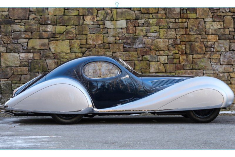 1937 TALBOT-LAGO T150-C-SS TEARDROP COUPE side profile parked in front of a brick wall.