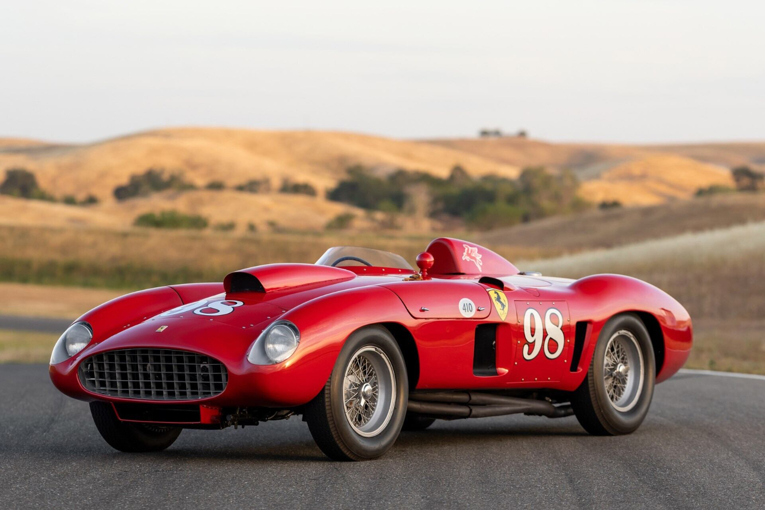 1955 Ferrari 410 Sport Spider front end angle from driver's side parked in front of rolling brown hills.