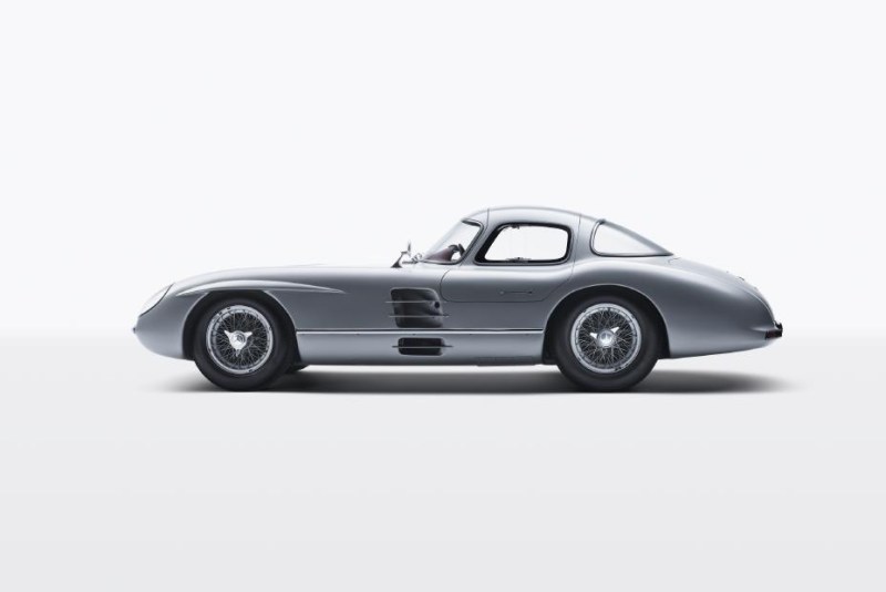 1955 Mercedes-Benz SLR “Uhlenhaut Coupé” 2 side profile in front of a white studio wall.