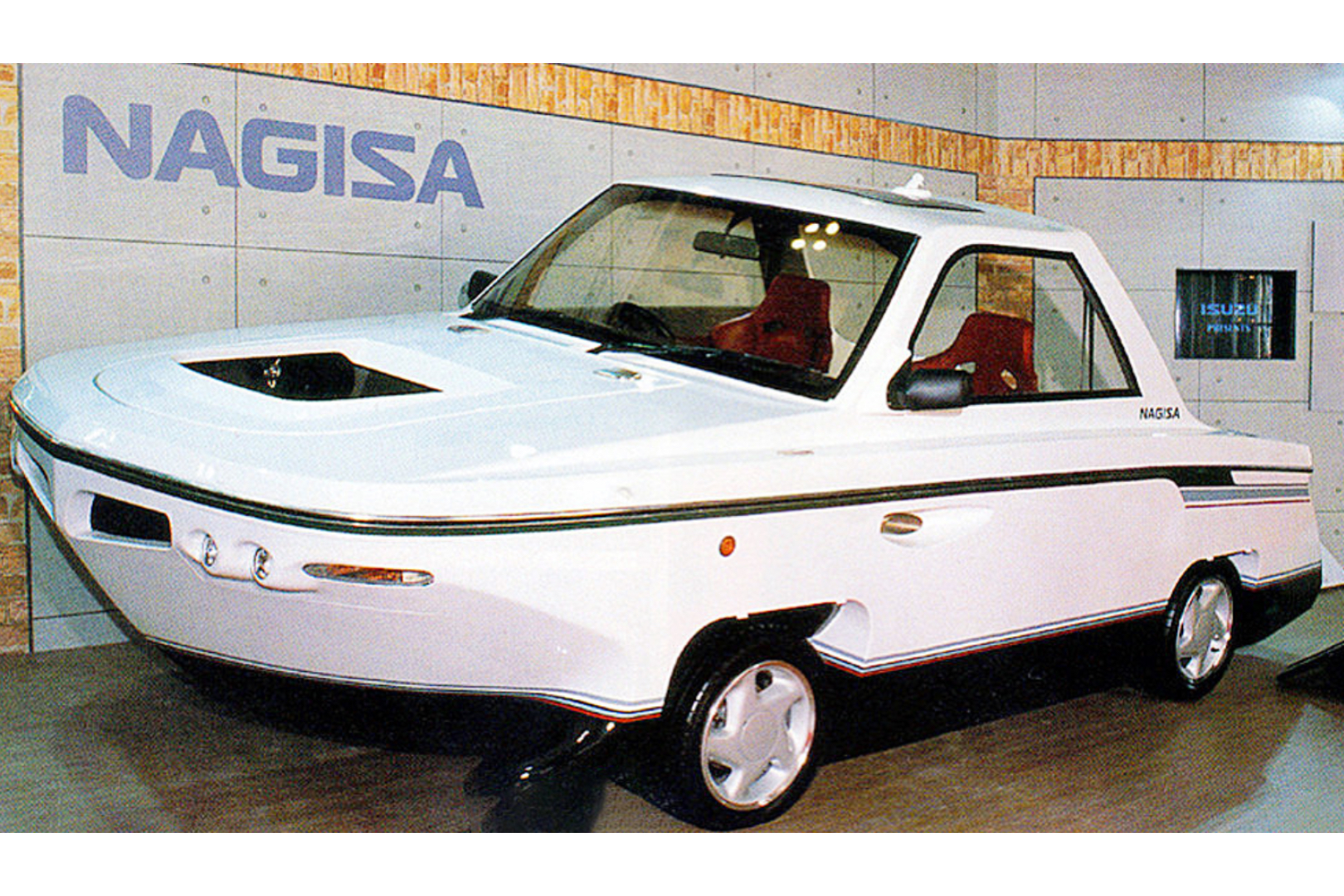 1991 Isuzu Nagisa front end angle sitting on a platform in front of a display.